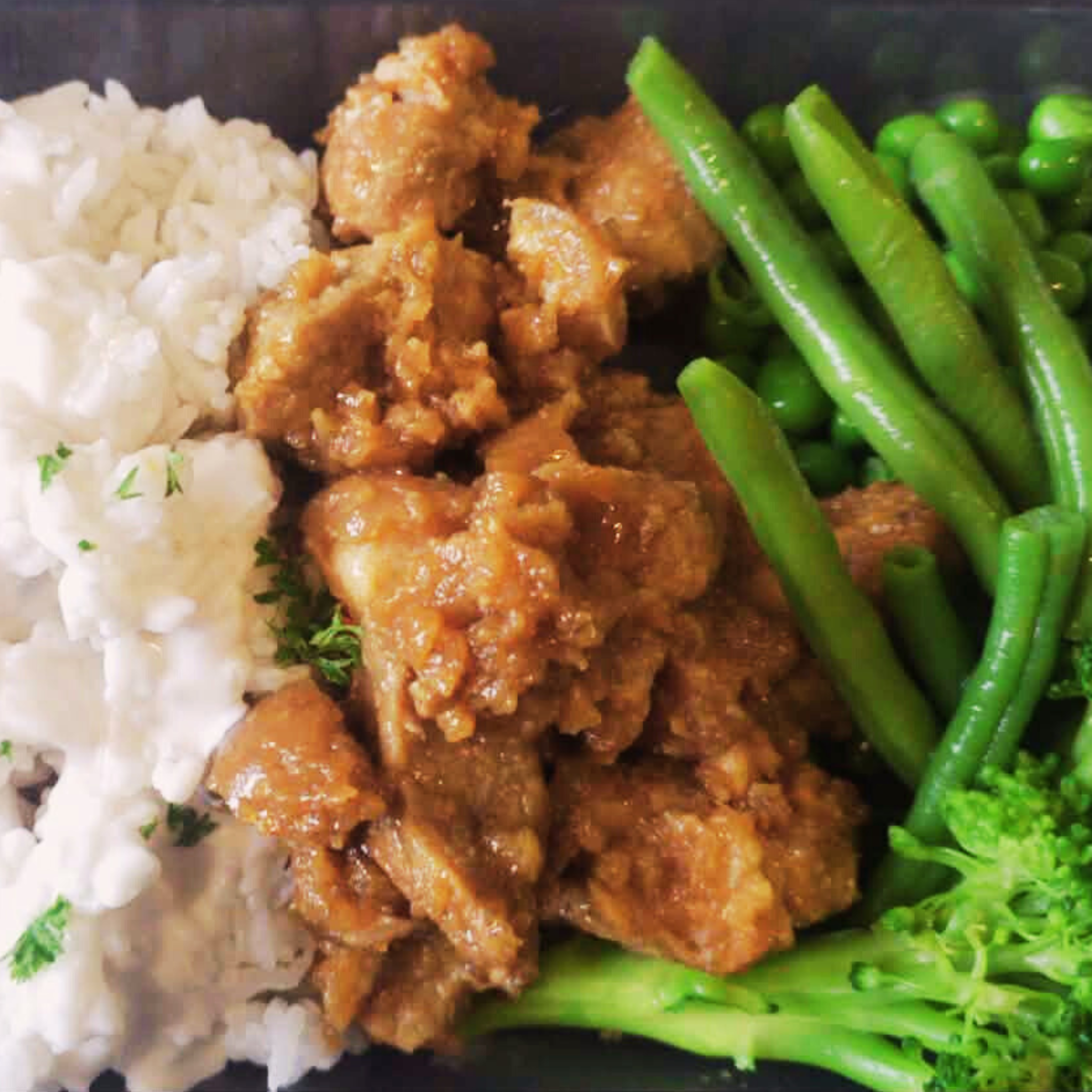 Sticky Ginger Pork with rice and vegetables on a plate. Made by the Nourish Queen.
